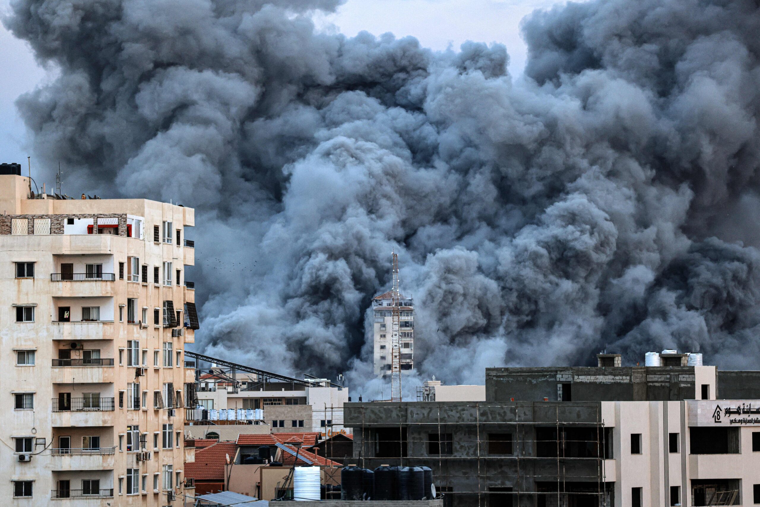 A plume of smoke rises above buildings in Gaza City on October 7 2023