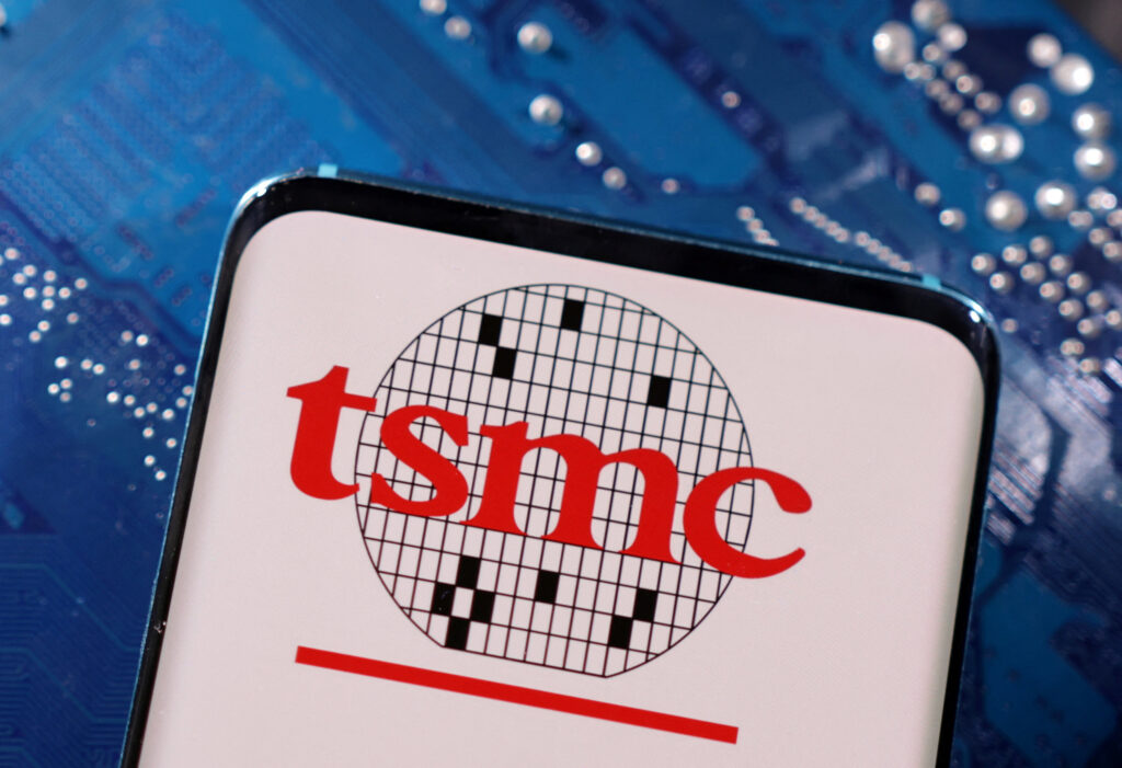 A smartphone with a displayed TSMC (Taiwan Semiconductor Manufacturing Company) logo is placed on a computer motherboard in this illustration taken.