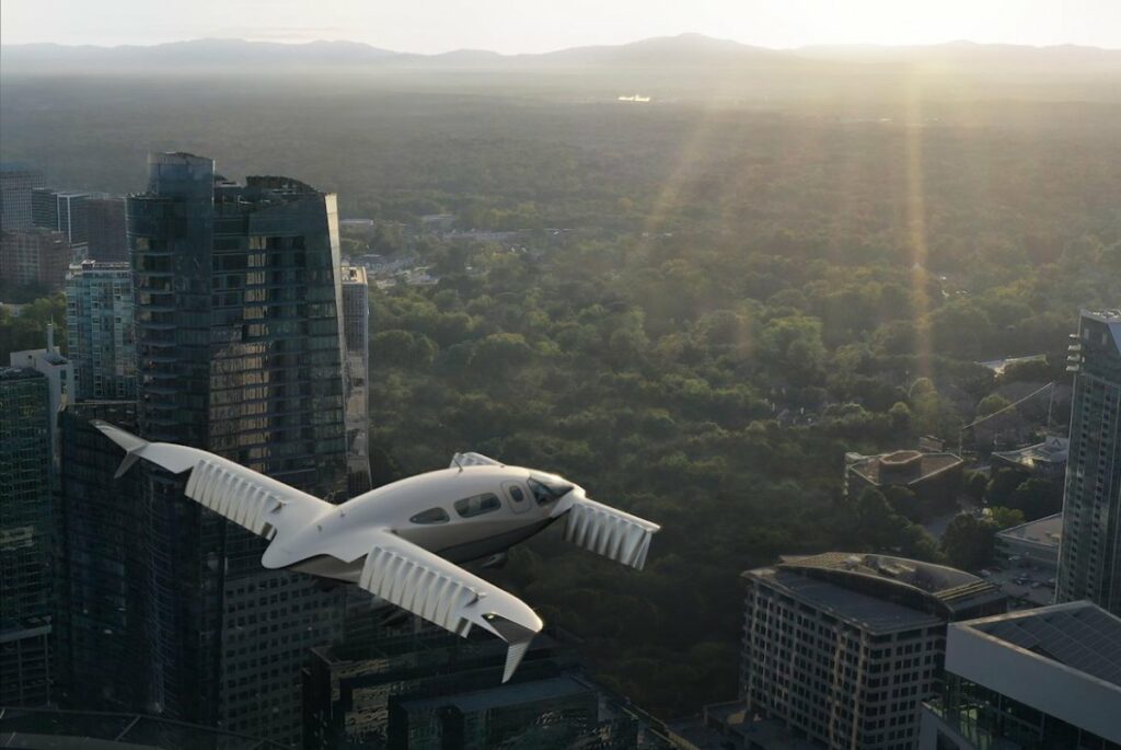 Lilium electric air taxi flying above a city with tall buildings and green landscapes in the background.