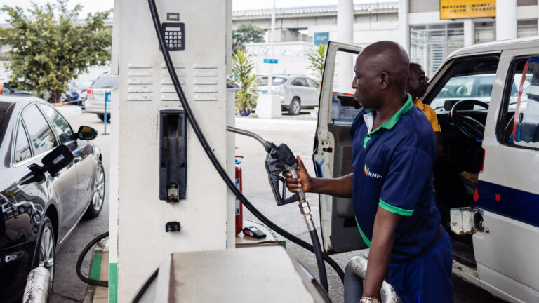 An attendant handles a fuel pump at a gas station in Lagos, Nigeria. Photographer: Benson beabuchi/Bloomberg