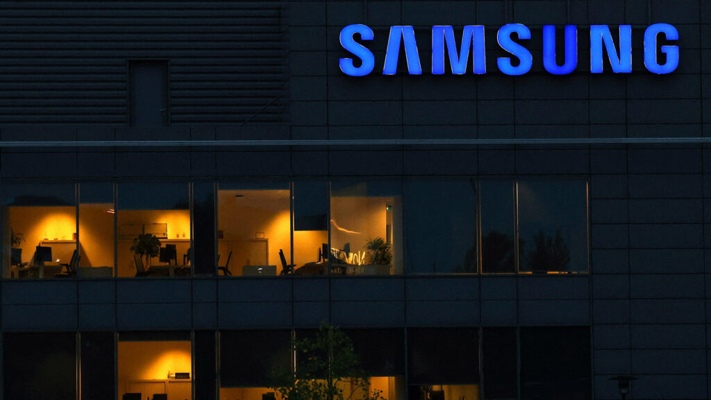 Samsung office building with the company logo illuminated at night showcasing office interiors through glass windows