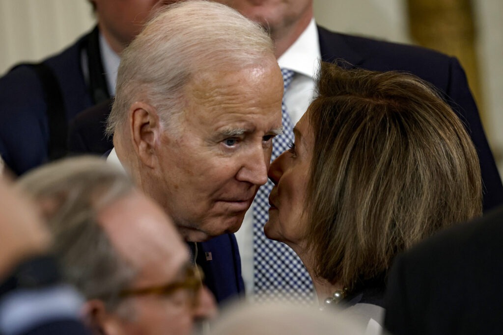 President Joe Biden and Nancy Pelosi in a close conversation during a public event in Washington, D.C.