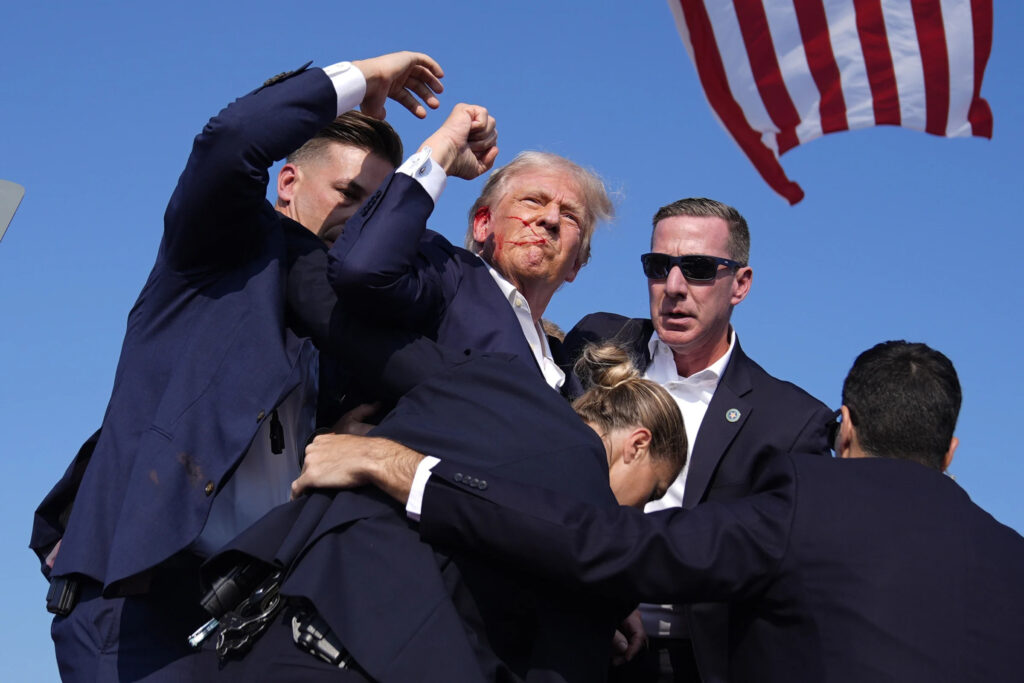 Former President Donald Trump is surround by U.S. Secret Service agents at a campaign rally. (AP Photo/Evan Vucci)