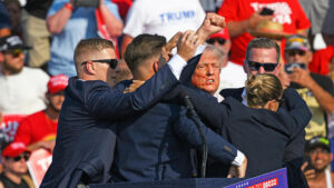 Butler, pennsylvania - july 13: secret service agents surround republican presidential candidate former president donald trump onstage after he was injured at a rally on july 13, 2024 in butler, pennsylvania. According to butler county district attorney richard goldinger, the suspected gunman is dead after injuring former president trump, killing one audience member and injuring at least one other. Photo by jeff swensen/getty images