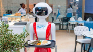 Nadia, a robot waiter at Robot Café, holding a tray with a meal, showcasing the use of robotics in the dining industry.