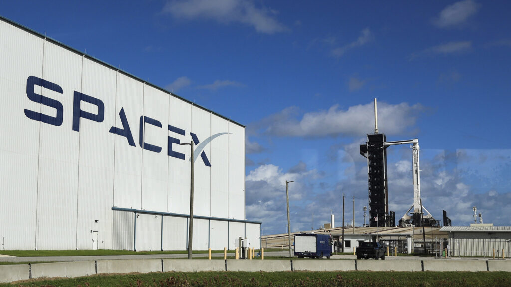 SpaceX facility with a Falcon 9 rocket on the launch pad at Kennedy Space Center, ready for a mission.