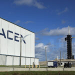 SpaceX facility with a Falcon 9 rocket on the launch pad at Kennedy Space Center, ready for a mission.