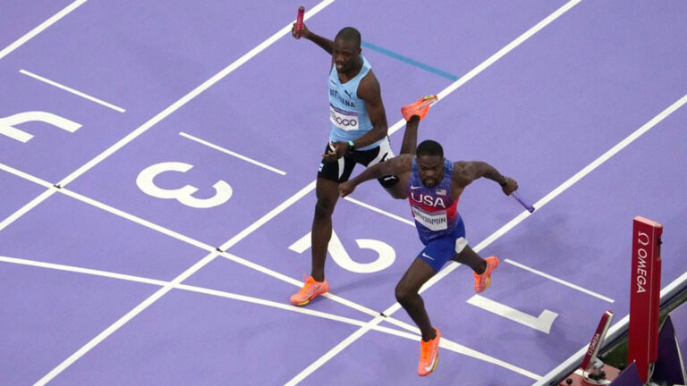 Rai Benjamin, right, of the United States, crosses the finish line ahead of Letsile Tebogo, of Botswana, to win the men's 4 x 400-meter relay final at the 2024 Summer Olympics.