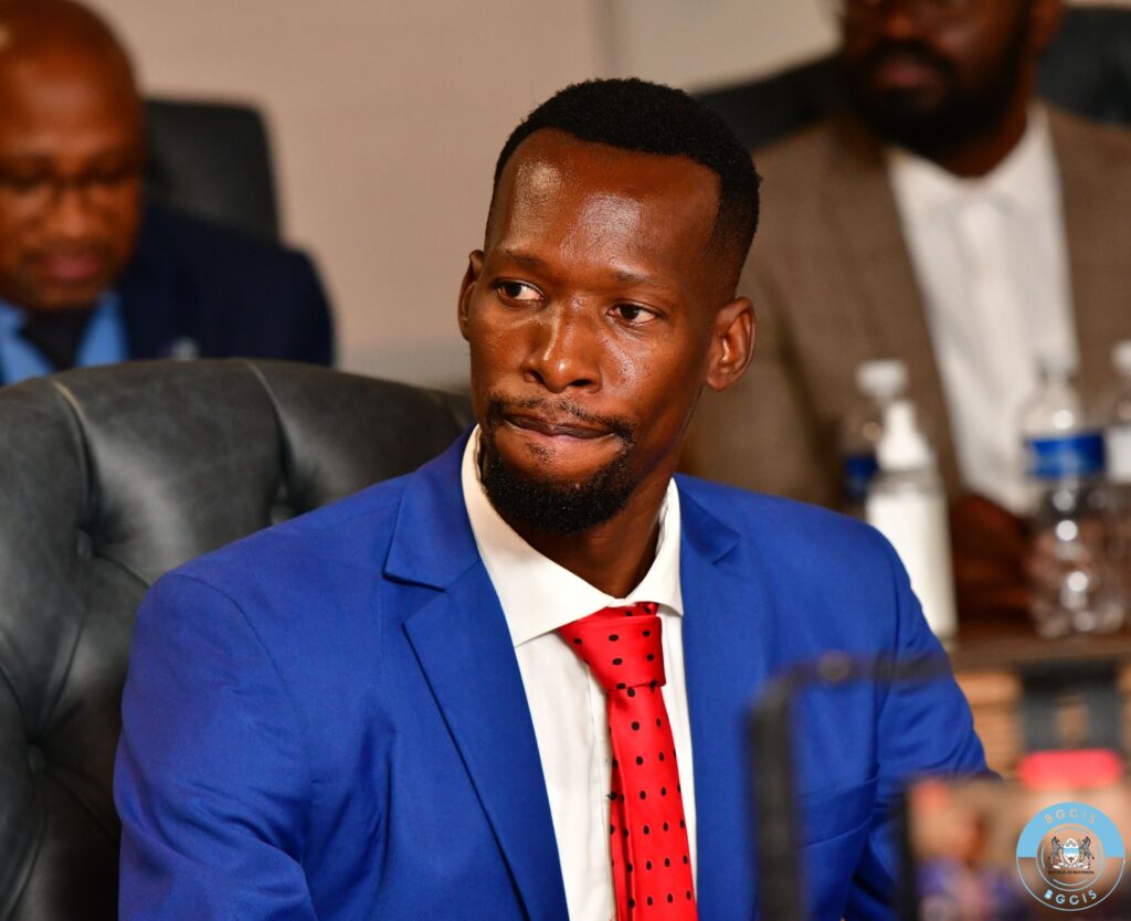 Lawrence ookeditse deputy minister of health at his appointment ceremony wearing a blue suit and red polka dot tie