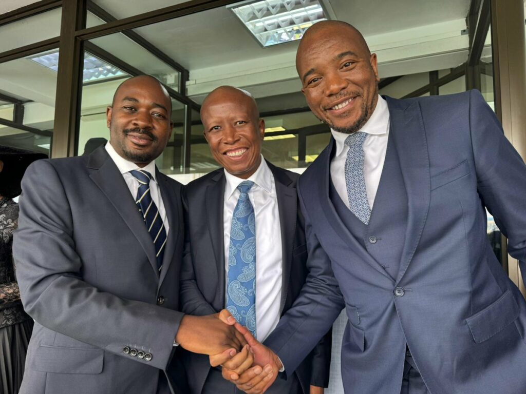 Nelson chamisa julius malema and mmusi maimane stand together smiling and shaking hands at the inauguration ceremony of botswana's President Duma Boko.