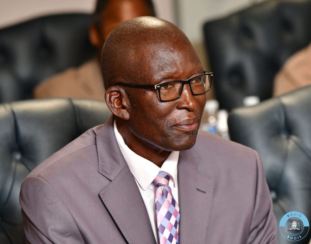 Dr Micus chiwasanee chimbombi minister of lands and agriculture seated at his appointment ceremony wearing a light gray suit and patterned tie