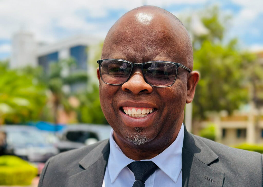 Assistant minister of local government and traditional affairs ignatius moswaane smiling outdoors during the swearing in of new cabinet ministers in botswana