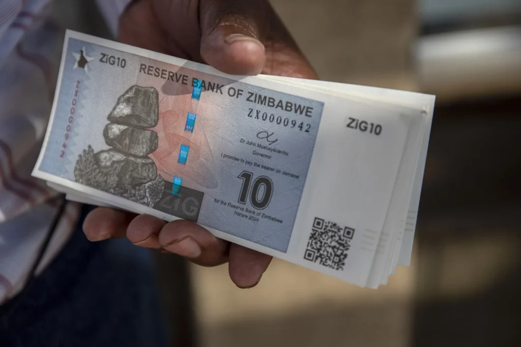 Hand holding a stack of zimbabwes new $10 gold backed currency notes introduced by the reserve bank of zimbabwe