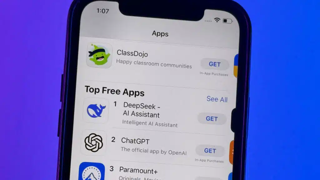 A smartphone screen showing the apple app stores top free apps with deepseek ai assistant ranked first chatgpt second and paramount+ third