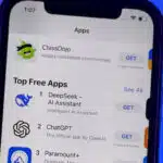 A smartphone screen showing the Apple App Store's top free apps, with DeepSeek AI Assistant ranked first, ChatGPT second, and Paramount+ third.