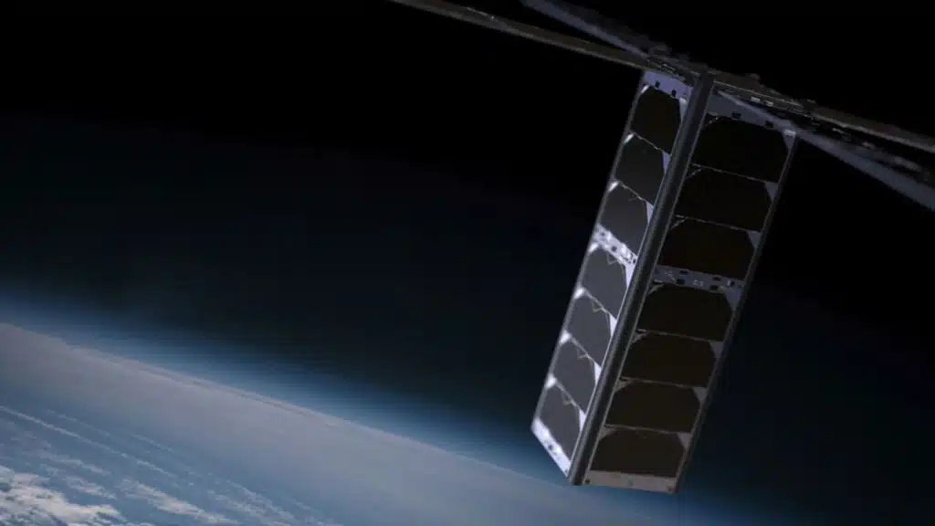 A eurosat satellite with extended solar panels floating above earth in space with the planets horizon visible in the background