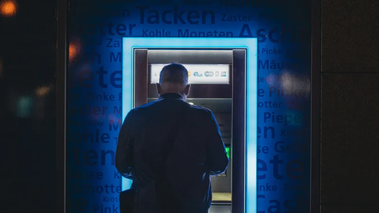 Safe Banking with ATM Access | Brimco Man using atm at night with glowing blue light