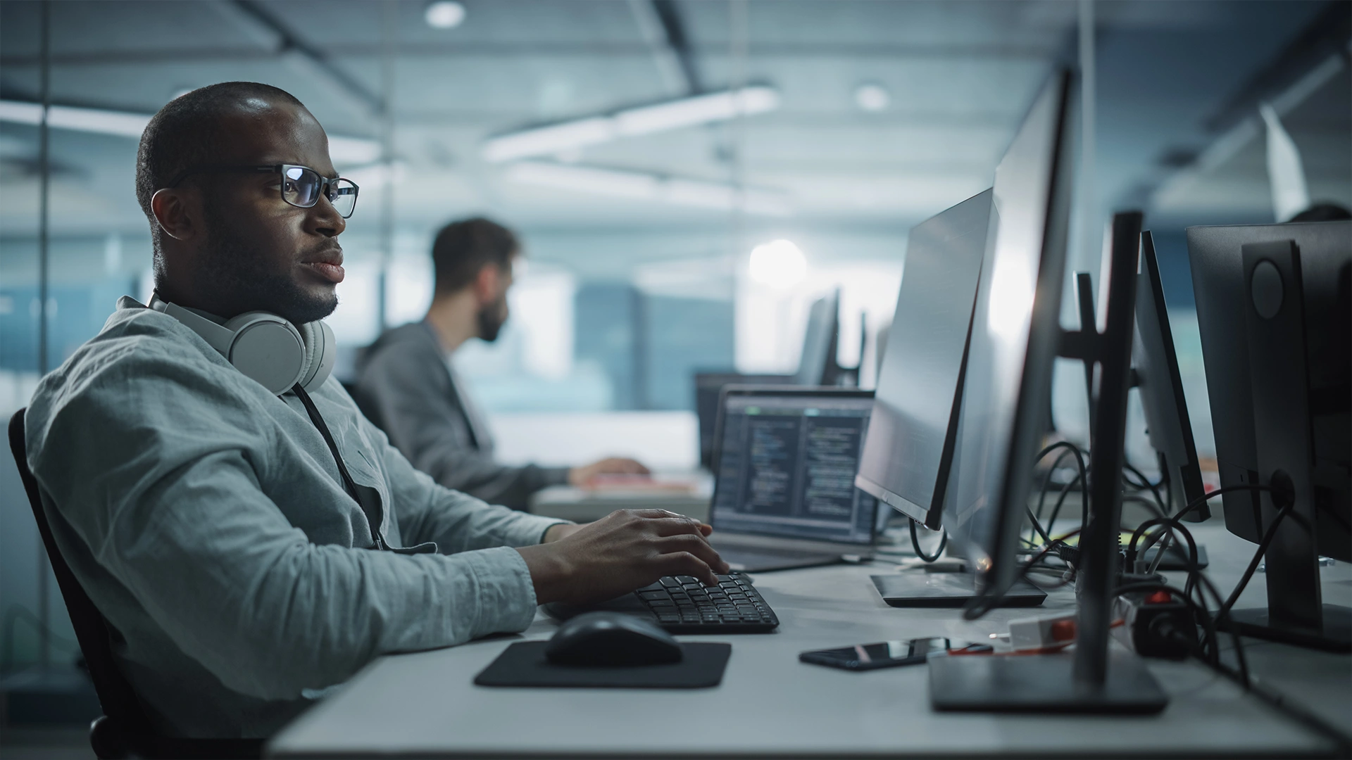 Benefits of IT Outsourcing for Businesses | Brimco It professional working at a computer in a modern office environment