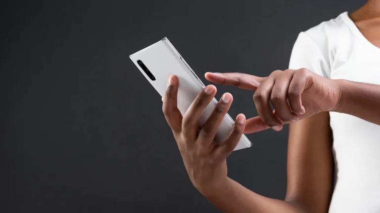 From App Idea to Product Plan: Turning Concepts into Reality | Brimco Person using a smartphone to design or plan a mobile app interface