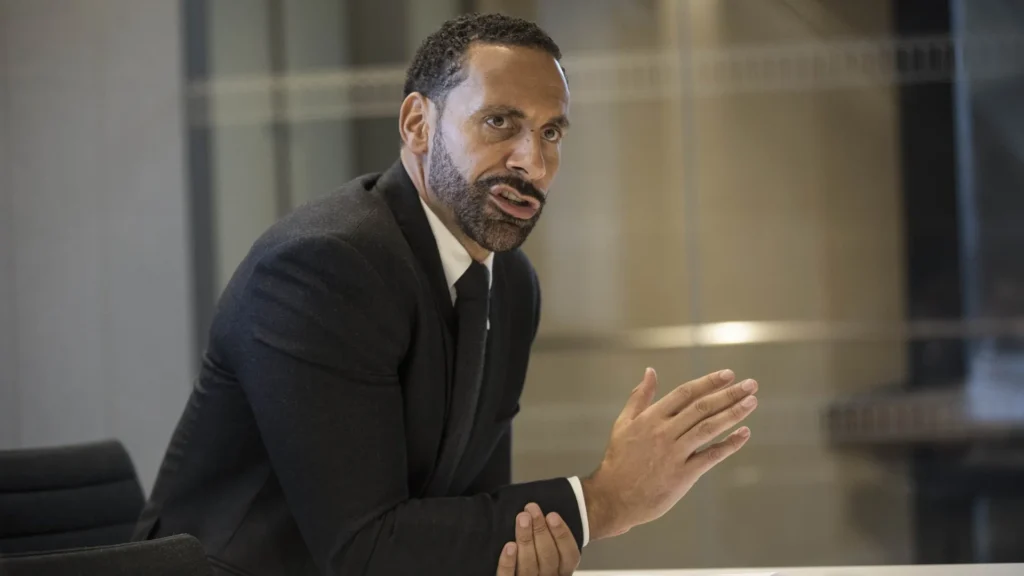 Rio Ferdinand Speaks on Leadership and Modern Football Business | Brimco Rio ferdinand in a suit speaking during a meeting gesturing with his hand while making a point