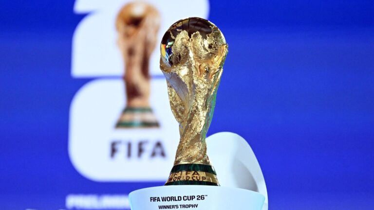 d2e52270-2c4a-11f1-934f-036468834728 | Brimco Close up of the gold fifa world cup trophy against a blue background