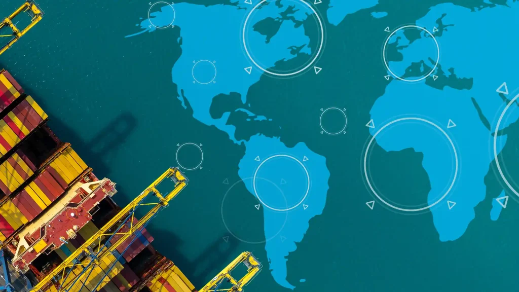 Cargo containers and cranes alongside a world map representing global trade and international business